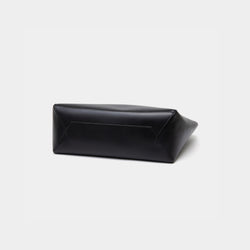 The bottom view of the black MOONSHAFT tote bag displayed against a white background. The bag features a sleek, minimalist design with reinforced stitching along the handles, emphasizing its spacious and structured silhouette.