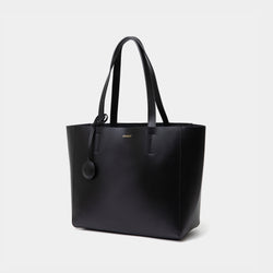 The diagonal view of the black MOONSHAFT tote bag displayed against a white background. The bag features a sleek, minimalist design with reinforced stitching along the handles, emphasizing its spacious and structured silhouette.