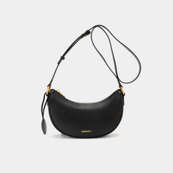 Front view of the Crescent Moon bag in black, featuring smooth leather with a minimalist design. The bag is shown with its adjustable crossbody strap and gold-tone hardware, highlighting the curved silhouette and simple elegance of the design.
