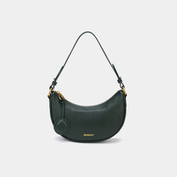 Front view of the Crescent Moon bag in pine grove, showcasing its smooth leather finish, curved silhouette, and gold hardware. The top handle is visible, along with an attached round coin purse accessory on the side. The minimal and elegant design highlights the bag's clean lines and structured shape.
