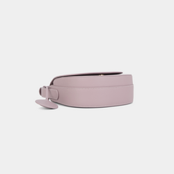 Bottom view of a Light Lilac half moon crossbody bag, highlighting the smooth leather texture and the circular leather tag detail.