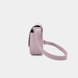 A side view of a light lilac half-moon crossbody bag showcasing its structured profile. The bag has a sleek, smooth leather finish, and its curved base complements the minimalistic design. The adjustable leather strap and gold-tone hardware are visible from this angle, adding a touch of refinement.