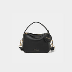 A close-up of the Mini Double Zip Bag in black color, made from pebbled leather. The bag features a top handle and an adjustable shoulder strap with gold-tone hardware. It has two zippered compartments for storage and a round leather tag attached to the side, embossed with the brand logo 'MOONSHAFT' in gold. The minimalist and structured design enhances its modern and stylish appeal.
