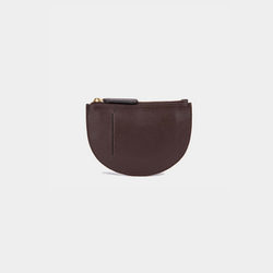 The back view of a brown Half Moon Coin Purse made of goat leather with a card slot on the back and a top zipper.