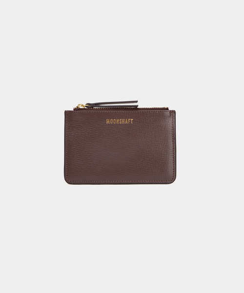 A compact leather cardholder in brown with a subtle textured finish. The cardholder features a gold zipper on top and the brand's logo "MOONSHAFT" embossed in gold on the front. The design is sleek and minimalist, suitable for carrying essential cards and small items.