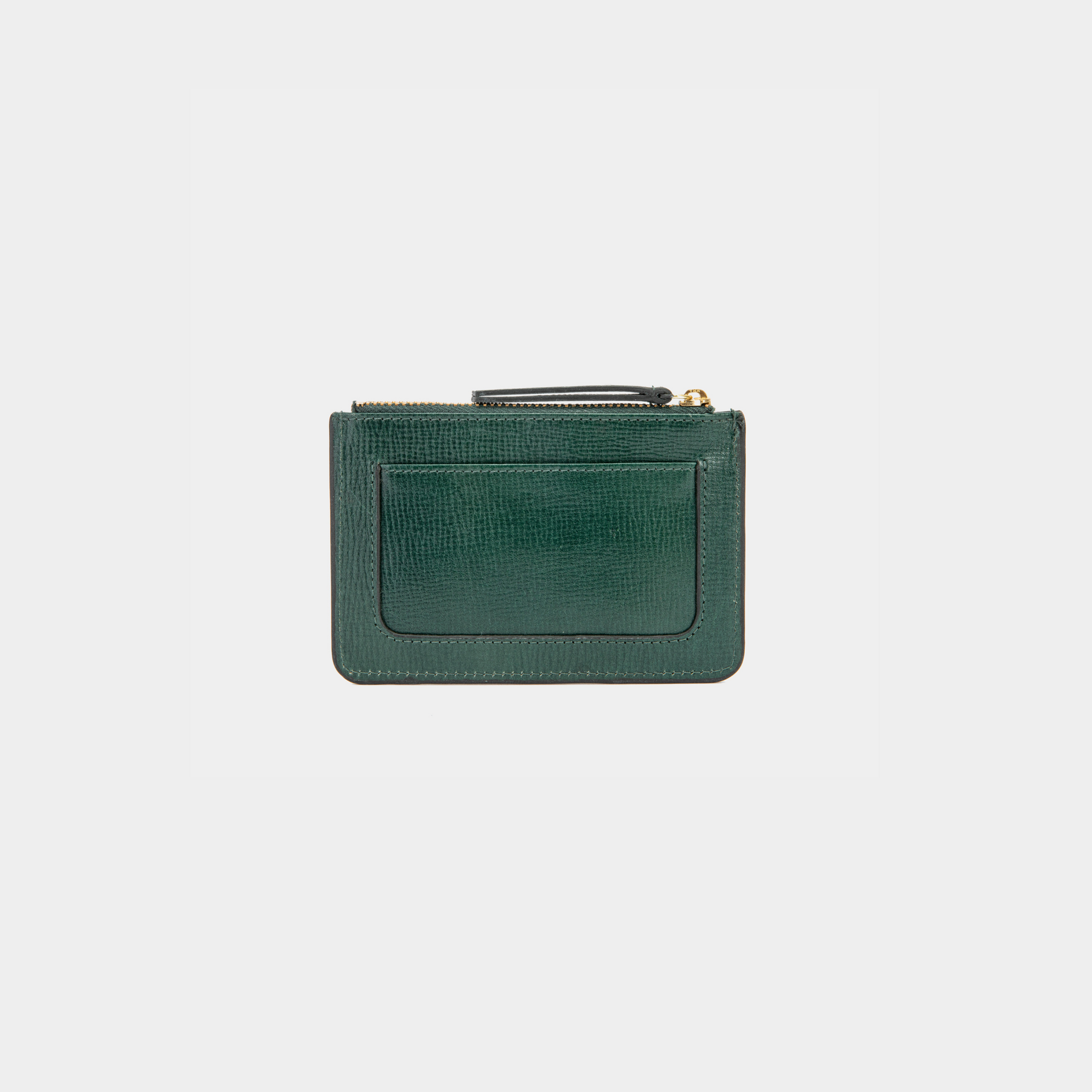 The image shows the back view of the dark green leather cardholder with a smooth, textured finish. It has an additional card slot on the exterior, ideal for easy access to frequently used cards. The cardholder also features gold-tone zipper hardware, adding a touch of elegance to its minimalist design.
