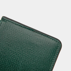 A close-up detail of the top corner of a dark green textured leather cardholder. The stitching is visible along the edge, showcasing the fine craftsmanship and durability of the material. The cardholder features clean, straight stitches, enhancing its structured finish.