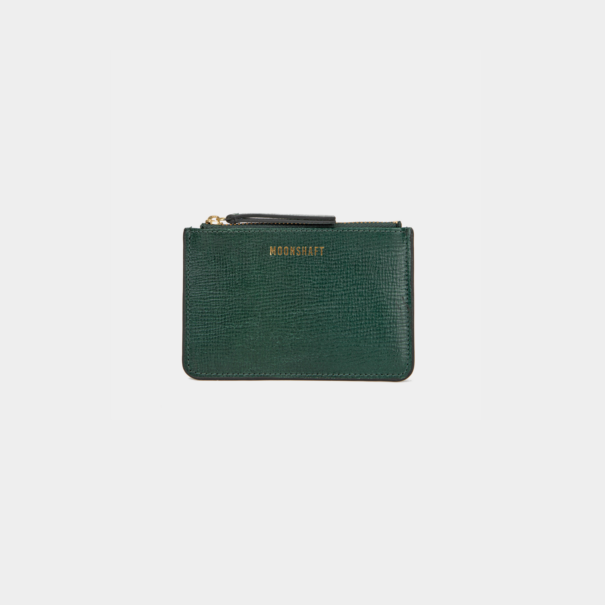 A compact leather cardholder in dark green with a subtle textured finish. The cardholder features a gold zipper on top and the brand's logo "MOONSHAFT" embossed in gold on the front. The design is sleek and minimalist, suitable for carrying essential cards and small items.