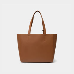 The back view of the caramel MOONSHAFT tote bag displayed against a white background. The bag features a sleek, minimalist design with reinforced stitching along the handles, emphasizing its spacious and structured silhouette.