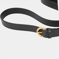 The adjustable black leather strap is shown in detail, featuring a gold-tone circular buckle that adds a sophisticated and functional element to the design. The smooth, sleek leather and precise stitching highlight the strap's quality and durability.