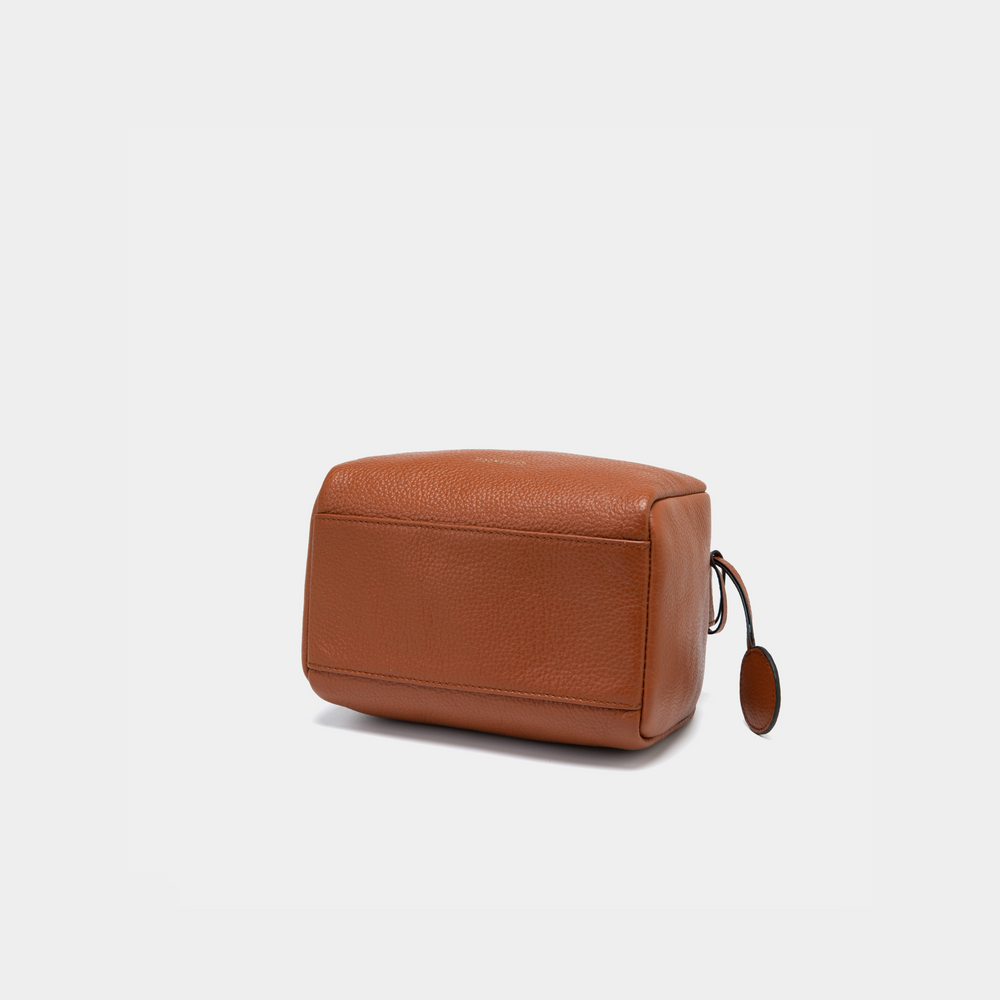 This image showcases the bottom view of the Moonshaft Loaf Bag in a tan color. The base is structured, featuring smooth, pebbled leather with reinforced stitching along the edges for durability. The tan color highlights the texture and craftsmanship of the leather, creating a refined, polished look for this structured bag. The smooth, minimalistic design of the base complements the overall aesthetic of the bag