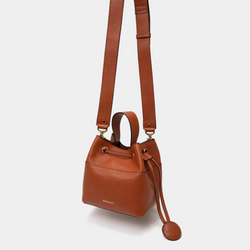Tan pebbled leather bucket bag with an adjustable wide shoulder strap for comfortable wear. The drawstring closure and coin pouch detail enhance both its practicality and stylish design.