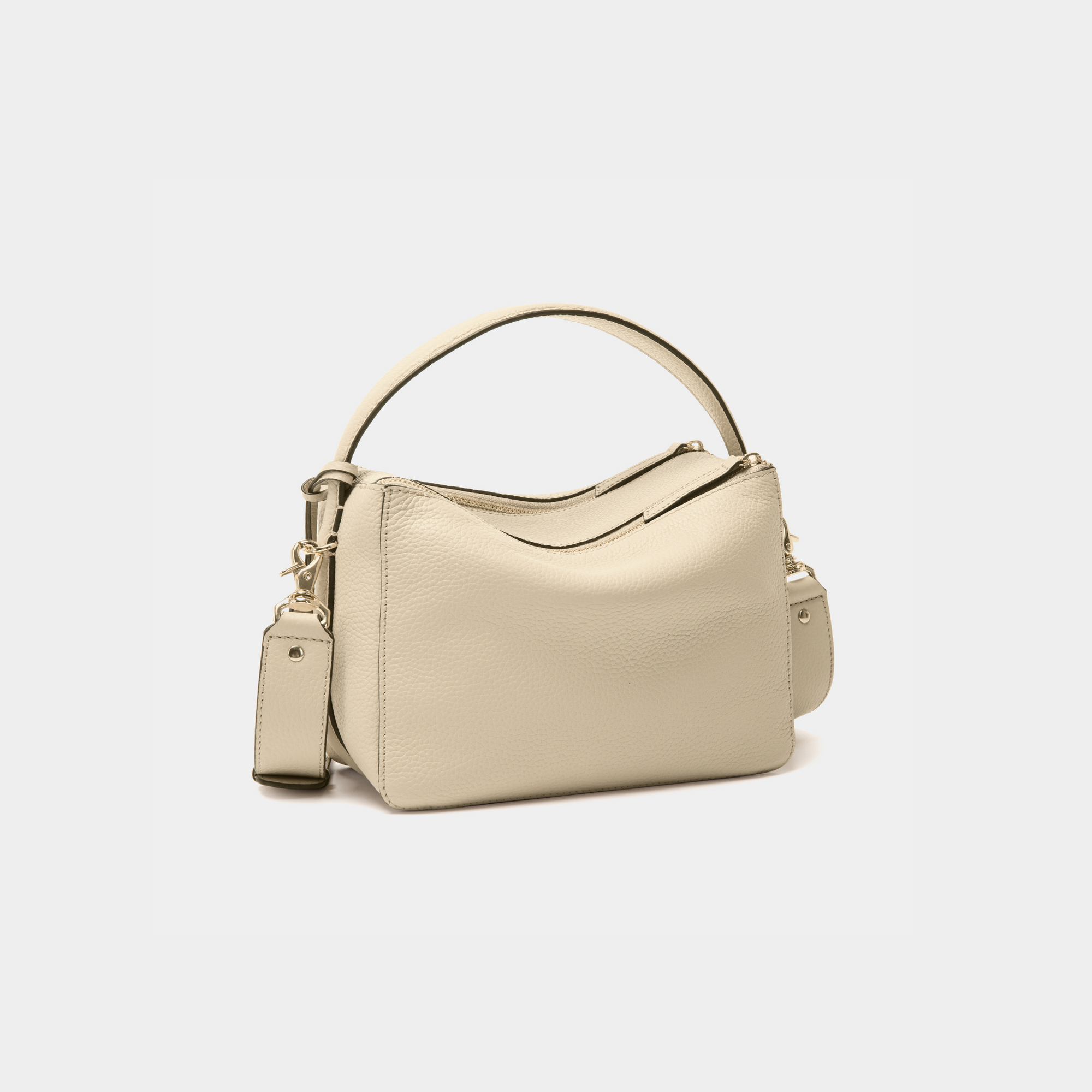 back view of the MOONSHAFT double zip pebbled leather bag in sand, featuring gold-tone zippers, a top handle, and a detachable strap.