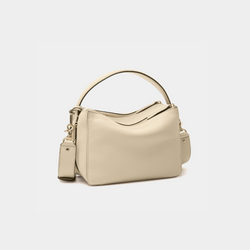 back view of the MOONSHAFT double zip pebbled leather bag in sand, featuring gold-tone zippers, a top handle, and a detachable strap.